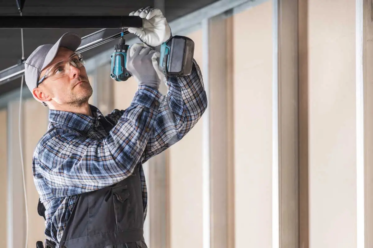 Garage Door Business Consulting 2 Skilled technician using power drill representing hands on experience supported by garage door business consulting