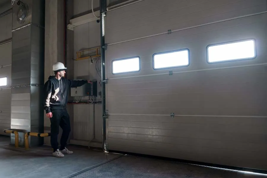 Commercial Garage Doors Marketing 2 Man in hardhat operating warehouse door controls