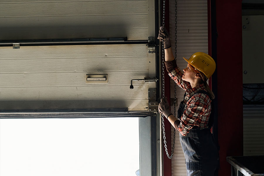 Commercial Garage Doors Marketing 1 Woman raising garage door in workplace setting